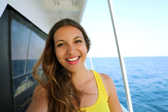 Selfie photo of young model woman on luxury travel cruise vacation in yellow dress enjoying the evening on Amalfi Coast getaway holidays. Happy traveler vacations in Italy. Copy space.