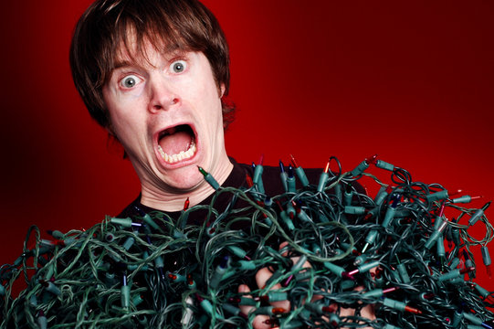 Man Stressed Over Tangled Christmas Lights