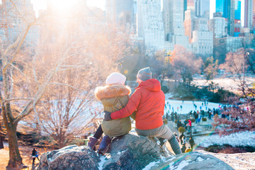 Happy couple enjoy the view of famous ice-rink in Central Park in New York
