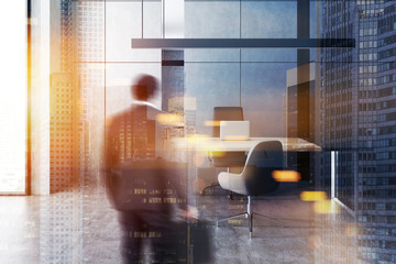 Man in minimalistic manager office, gray walls