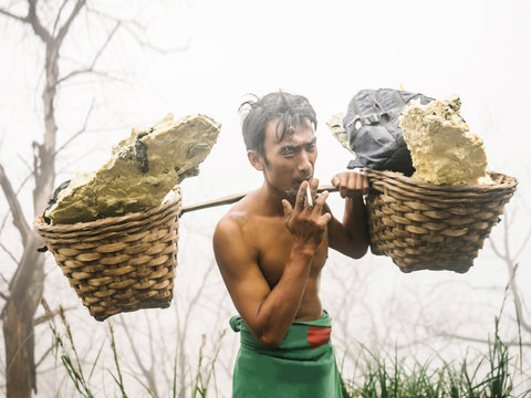 Resting laborer smoking in sulfur vapors