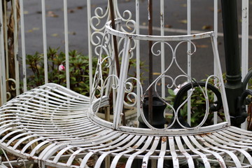 The old wraparound white metal seat is certainly an antique.