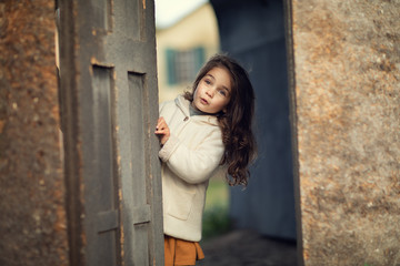 girl looking out from behind doors
