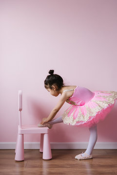 Adorable ballet girl wearing shoes