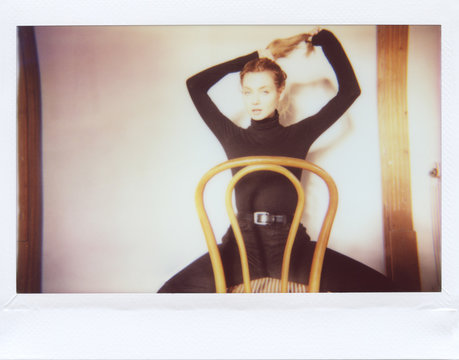 Amazing young blonde sitting on chair