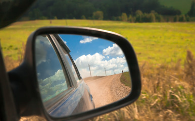 adventure and travel view reflection in the car side mirror of the world and the road