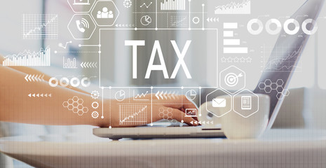 Tax with woman using a laptop on a coffee table 