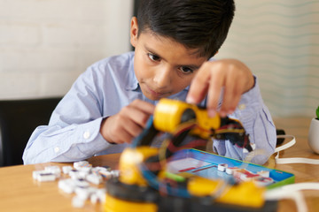 Young boy assembling a robot