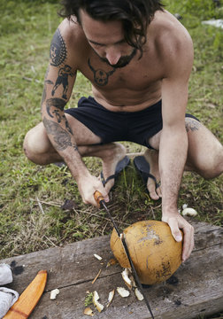 Man opening coconut