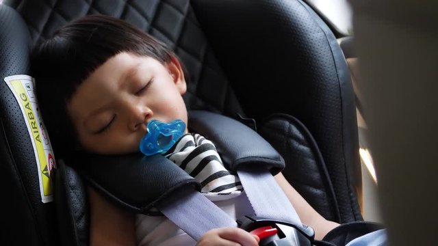 cute child sleeping in car seat safe drive