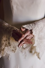 Detail of a white and elegant wedding dress.
