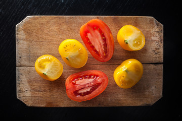 Red and Yellow tomatoes on vintage chopping board
