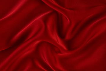 Fototapeta na wymiar Red silk fabric background, view from above. Smooth elegant red silk or satin luxury cloth texture can use as abstract background with copy space. 