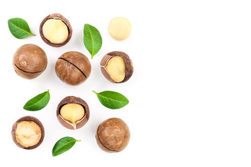 Shelled and unshelled macadamia nuts with leaves isolated on white background with copy space for your text. Top view. Flat lay pattern