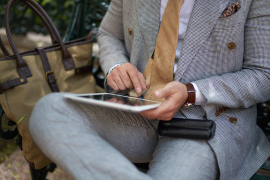Man in a suit using a tablet