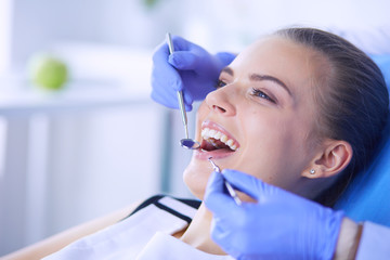 Young Female patient with open mouth examining dental inspection at dentist office. - 227550914