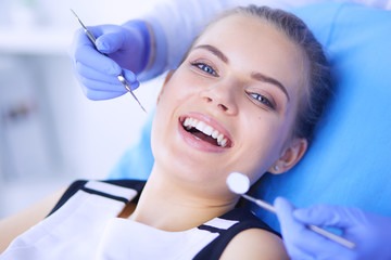 Young Female patient with open mouth examining dental inspection at dentist office. - 227550993
