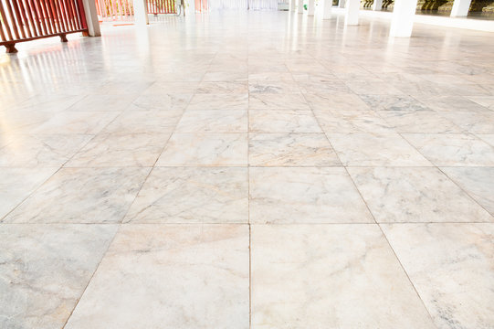 Real marble floor tile in perspective with beige abstract texture pattern of natural material i.e. stone, rock. Smooth surface for decorative wall, floor of interior building i.e. bathroom, kitchen.