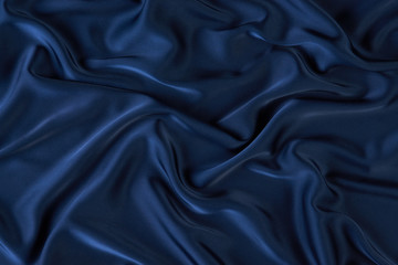 Dark blue silk fabric background, view from above. Smooth elegant blue silk or satin luxury cloth texture can use as abstract background with copy space, close-up 