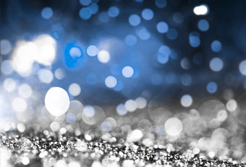holiday abstract glitter background with blinking stars and falling snowflakes. Blurred bokeh of...