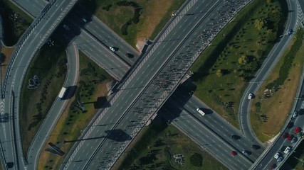 Aerial drone footage. Top circular view marathon running on the road junction, close up