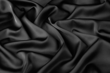 Obraz premium Black silk fabric background, view from above. Smooth elegant black silk or satin luxury cloth texture can use as abstract background with copy space, close-up 