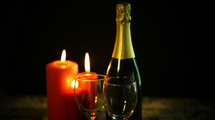Bottle of champagne with Christmas candles
