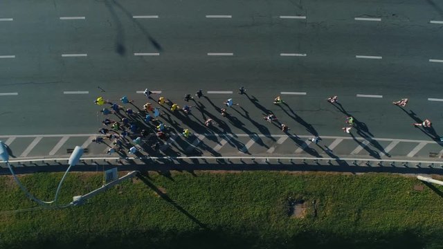 Aerial Drone Fooage. Following Marathon Running On road bridge. Top View