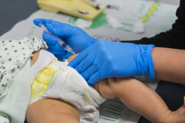 Vaccination shot to infant at pediatrics