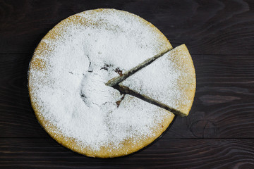 homemade Apple pie on brown wooden background top view