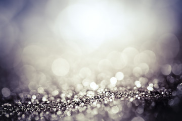 abstract Christmas background with holiday lights and copy space - magic bokeh glitter with blinking stars and falling snowflakes