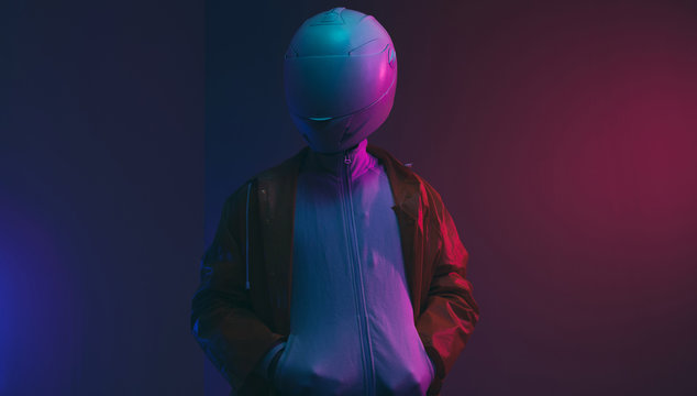 Futuristic person /anonymous with white helmet/mask iluminated with neon light.