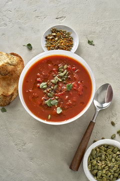 Vegan Tomato Bisque with olive oil, fresh herbs, and pumpkin see