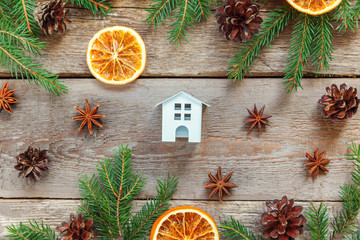 Christmas New Year composition winter objects toy house fir branch orange slices on old shabby rustic wooden background Xmas holiday december decoration Flat lay top view Time for celebration