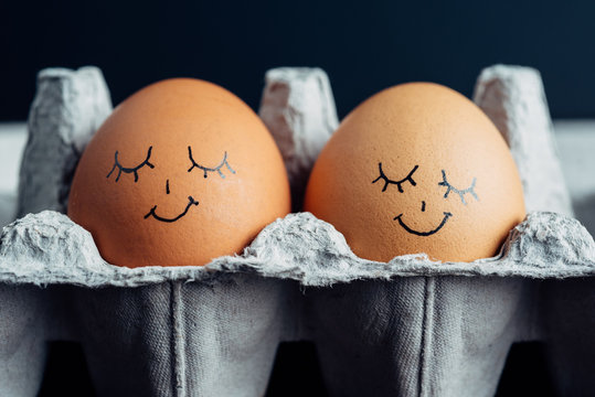 Pair of napping eggs in a carton