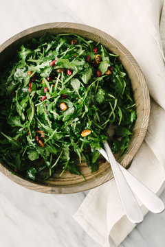 Overhead view of Arugula or ""Rocket"" Salad with Pomegranate seeds