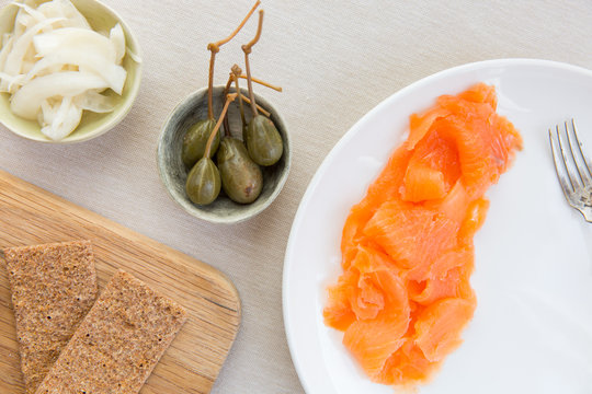 A scandinavian inspired light meal of smoked salmon, scandinavian crackers, pickled vegetable and caper berries.