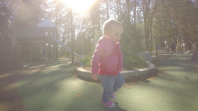 Toddler Girl Walking in Park on Sunny Day