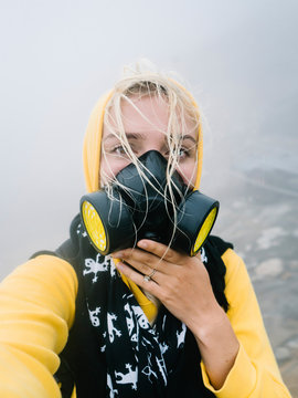 Girl taking selfie in smoke of sulfur