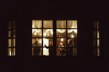 Family in the night window