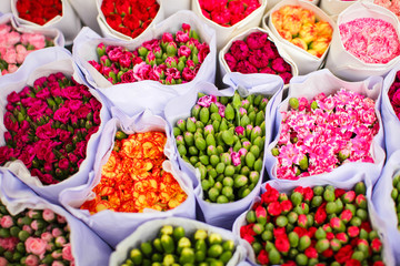 Several bouquets of carnation ready for sale in a street flower market