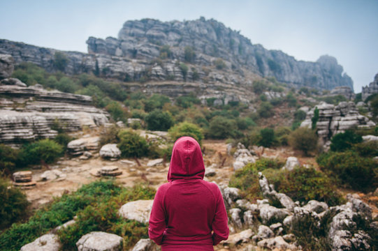 Woman in hoodie looking at El Torcal de Antequera