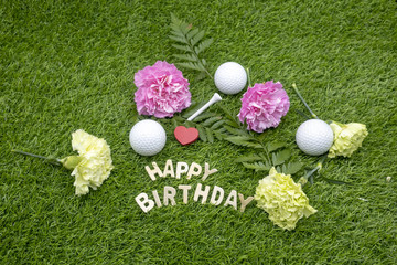 Happy Birthday to golfer with golf ball and tee on green grass
