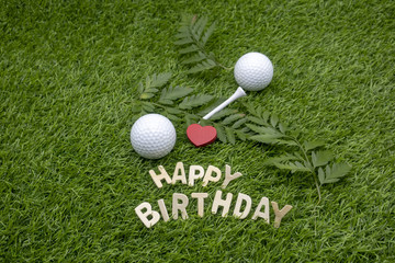 Happy Birthday to golfer with golf ball and tee on green grass