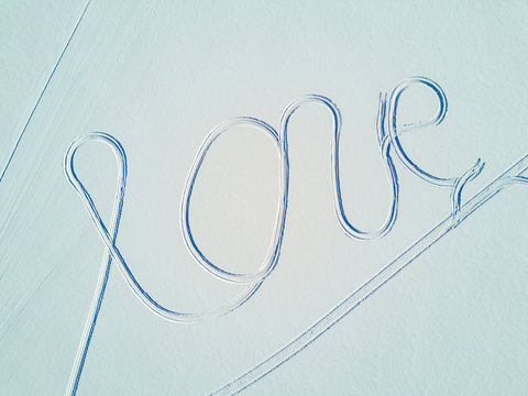 The word love on a white snow