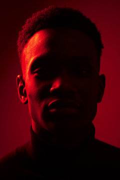 African American man portrait under red lights
