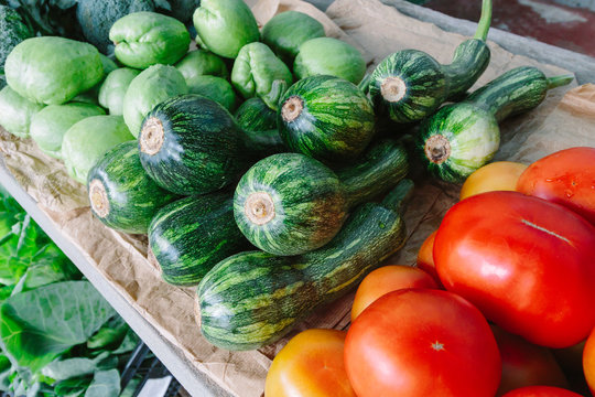 Organic chayote, zucchini and tomatoes at a farmer's market in Madeira