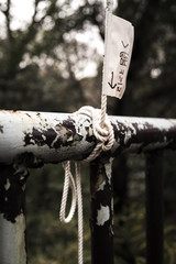 message and rope tied to a metal bar