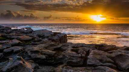 sunset over seaside and rocks