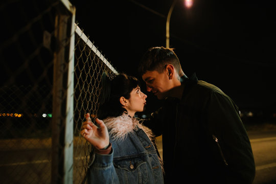 Loving young couple in night on street